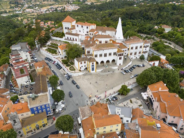 View from above of an idyllic town with many white and colourful roofs, surrounded by trees and hills, aerial view, Royal Palace, Palácio Nacional de Sintra, National Palace, Sintra, Lisbon, Portugal, Europe