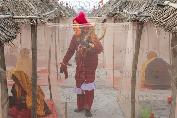 A devotee dressed as Hindu monkey-faced God Hanuman, standing next to camps, on the eve of consecration ceremony of the Ram temple, in Ayodhya, Uttar Pradesh, India on 22 January 2024