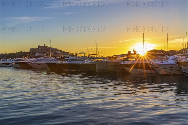 Luxury yachts under a low sun in the harbour of Eivissa, Ibiza Town, Ibiza, Balearic Islands, Mediterranean Sea, Spain, Europe