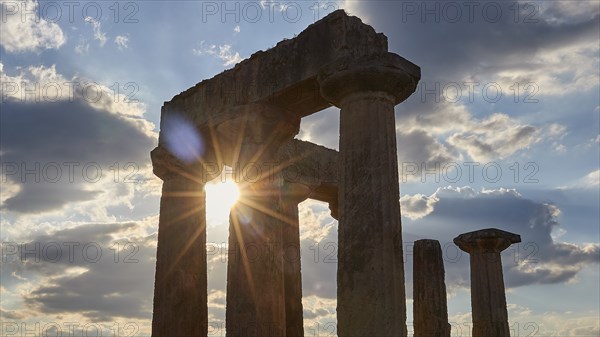 Archaic Temple of Apollo, Doric columns, The sun shines through ancient column ruins, Archaeological site, Archea Korinthos, Corinth, Peloponnese, Greece, Europe