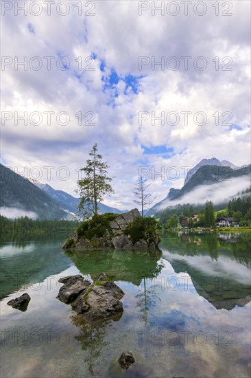 Hintersee with rocks and trees in the foreground, surrounded by mountains, cloudy sky, Ramsau, Berchtesgaden National Park, Berchtesgadener Land, Upper Bavaria, Bavaria, Germany, Europe