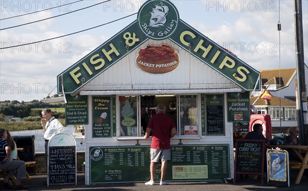 Traditional seaside Fish and Chips small shop booth at West Bay, Bridport, Dorset, England, UK