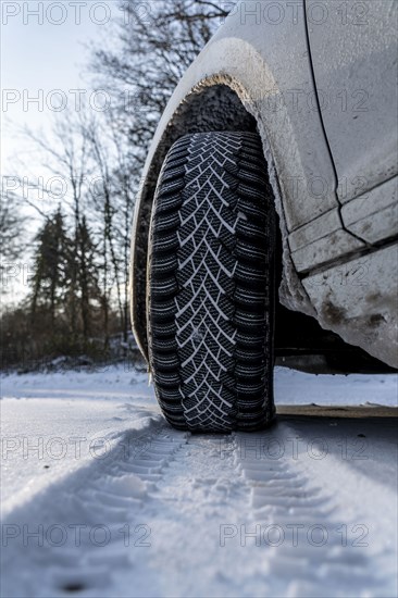 Winter tyres, driving on a road with snow cover, grip on the snow thanks to the special tread and rubber compound, the tyre for winter