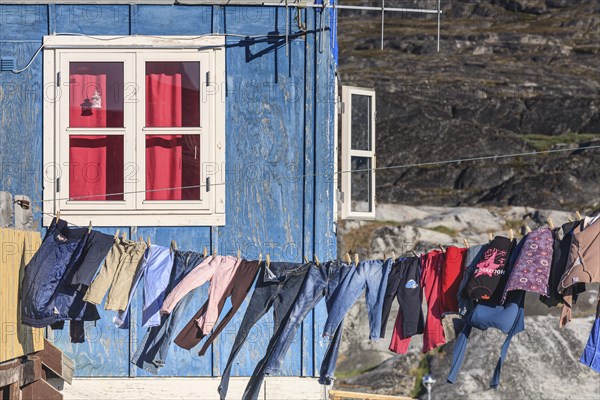 Laundry drying in the wind in front of the house, Inuit settlement, Ittoqqortoormiit, East Greenland, Greenland, North America