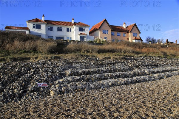 Gabion steel cages containing rocks form coastal defences at Thorpeness, Suffolk, England, UK