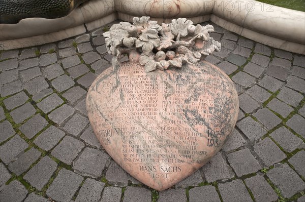 Heart with a poem by Hans Sachs, 1541, in front of the fountain Ehekarussel by Jürgen Weber, erected 1984, Nuremberg, Middle Franconia, Bavaria, Germany, Europe