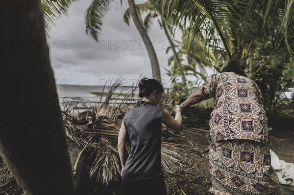 (L-R) Annalena Bärbock (Bündnis 90/Die Grünen), Federal Foreign Minister, and Lavenia McGoon, resident of the Togoru settlement, photographed during a briefing on coastal erosion at a cemetery near the Togoru settlement flooded by rising sea levels, 07.05.2024. Bärbock is travelling to Australia, New Zealand and Fiji for political talks / Photographed on behalf of the Federal Foreign Office