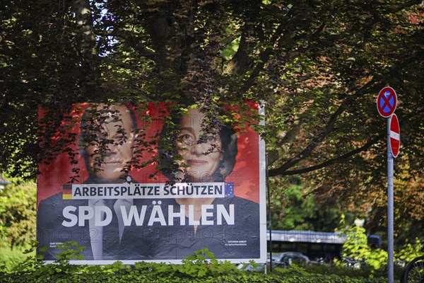 An SPD election poster for the European elections with Federal Chancellor Olaf Scholz and lead candidate Katarina Barley stands under a tree in Berlin Hermsdorf. Berlin, 08.05.2024