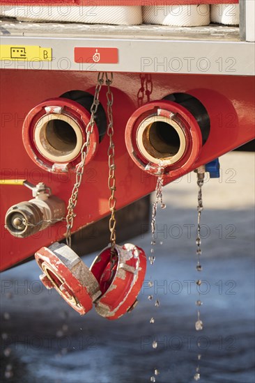 Close-up of fire engine with open water connections and dripping water, fire brigade, Enzklösterle, Black Forest, Germany, Europe