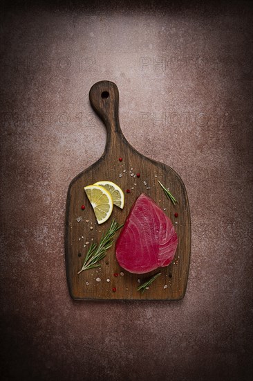 Fresh red tuna fillet, for steak, raw, top view, on a cutting board, no people