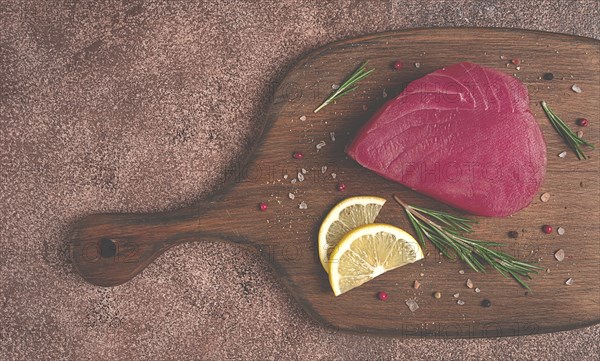 Fresh red tuna fillet, for steak, raw, top view, on a cutting board, no people