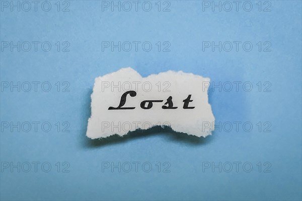 A piece of paper with the word 'Lost' on a blue background, minimalist