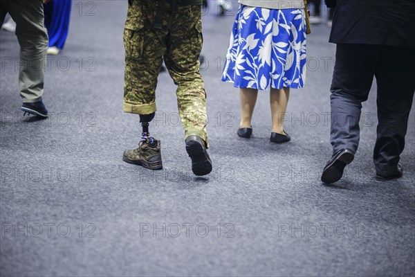 Ukraine Recovery Conference URC in Berlin. A Ukrainian soldier with a prosthesis walks through an exhibition hall. 'ÄôPhoto taken as Official Photographer'Äô