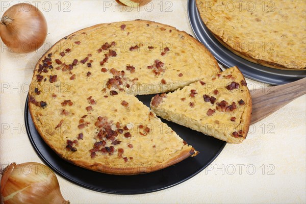 Swabian cuisine, onion tart vegetarian and classic with bacon, baked, savoury, savoury cake, typical Swabian, home cooking, cake tin, from the oven, wooden spatula, traditional cuisine, food photography, studio, Germany, Europe