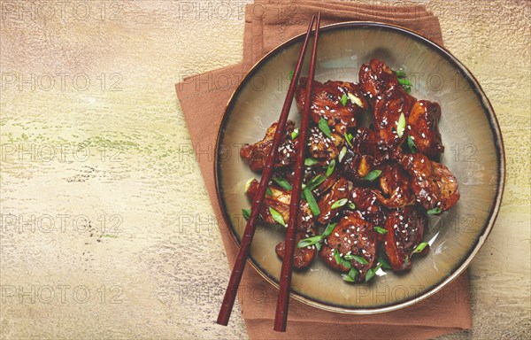 Yakitori chicken kebab, on a plate, with green onions and sesame seeds, top view, no people