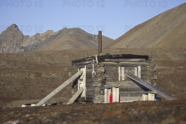 Wooden hunting log cabin tightly shut with logs against raiding polar bears on Svalbard, Spitsbergen, Norway, Europe