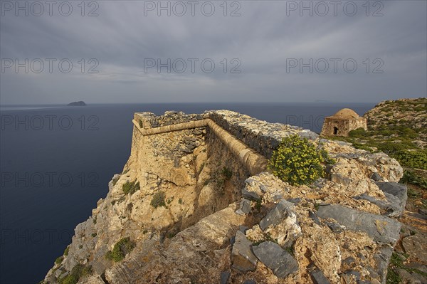 Venetian sea fortress Gramvoussa, morning light, cloudy sky, fortress walls, Pontikos Island, yellow spherical flowering perennial, square defence defence tower, Gramvoussa Peninsula, Pirate's Bay, Balos, Tigani, Western Crete, Crete Island, Greece, Europe