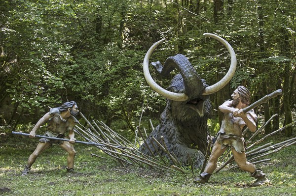 Diorama showing Neanderthal hunters killing trapped prehistoric mammoth at Prehisto Parc, theme park about prehistoric life at Tursac, Périgord, Dordogne, France, Europe