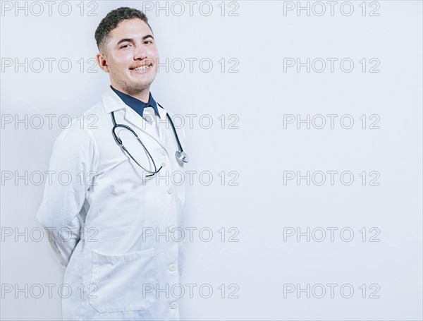 Portrait of smiling young doctor isolated. Portrait of latin doctor isolated with copy space