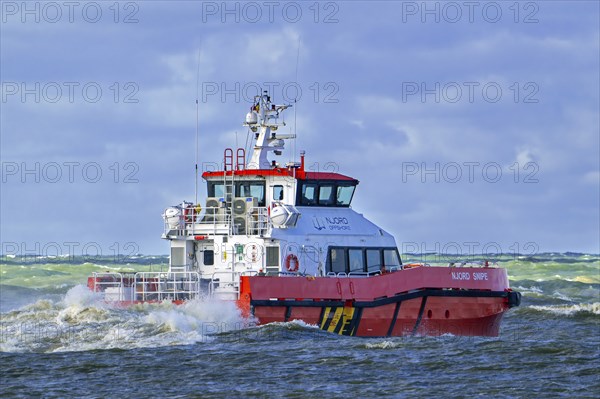 Njord Snipe, catamaran operated by Njord Offshore Ltd, crew transfer vessel for offshore windfarm sector sailing on the North Sea in stormy weather