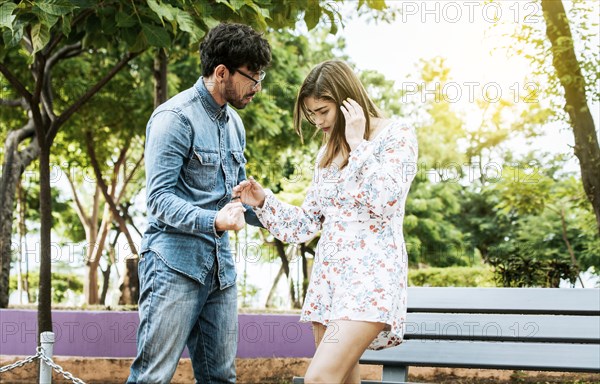 Young couple arguing misunderstanding in a park, Unhappy couple standing arguing in a park. Disgusted teenage couple arguing in a park, Man and woman arguing in a park