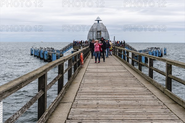 Sellin, Germany, August 1, 2019: Famous Sellin Seebruecke, Sellin Pier, a cloudy day of summer, Ostseebad Sellin tourist resort, Baltic Sea, Europe