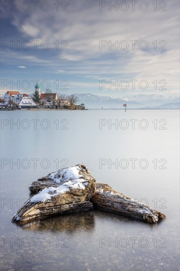 Wooden trunks picturesque church of St. George on the lakeshore in front of snow-covered Pfänder on a clear winter day, moated castle, Lake Constance, Bavaria, Germany, Europe