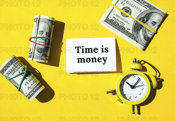 Dollar banknote with paper note for copy space. Savings investment, Salary. Finance concept. Business budget of wealth and prosperity finance. Alarm clock. Time is money