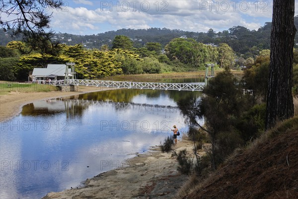 An angler at a lovely spot by the Erskine River near the Swing Bridge, Lorne, Victoria, Australia, Oceania