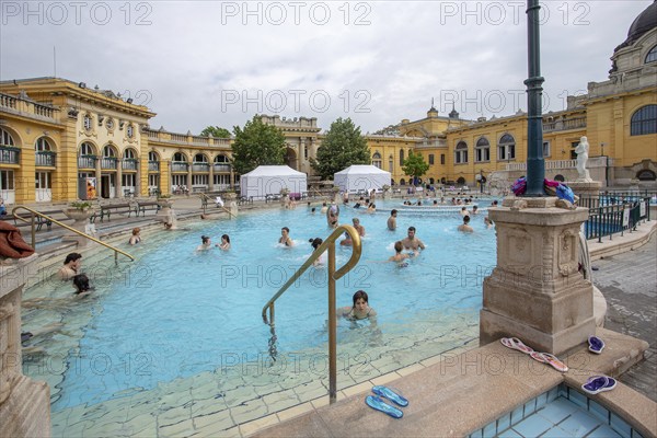 04-26-2014. Budapest, Hungary. People outdoors in pool of Szechenyi Thermal Baths, 1909 year of bulding, Awe Spring day!