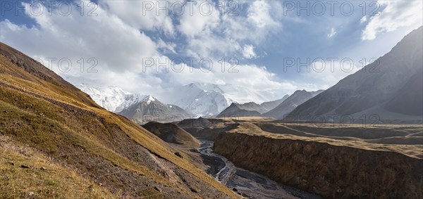 Valley with river Achik Tash between high mountains, mountain landscape with glaciated peak Pik Lenin, Trans Alay Mountains, Pamir Mountains, Osh Province, Kyrgyzstan, Asia