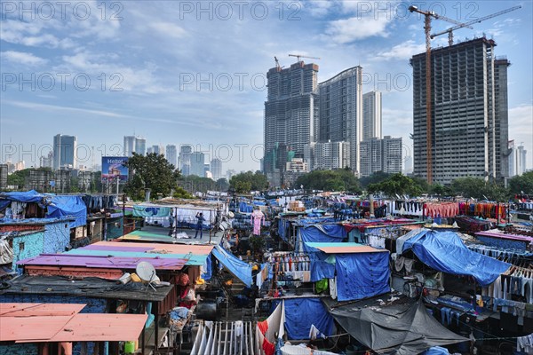 MUMBAI, INDIA, OCTOBER 31, 2019: Dhobi Ghat (Mahalaxmi Dhobi Ghat) is open air laundromat lavoir in Mumbai, India with laundry drying on ropes. Now signature landmark tourist attractions of Mumbai