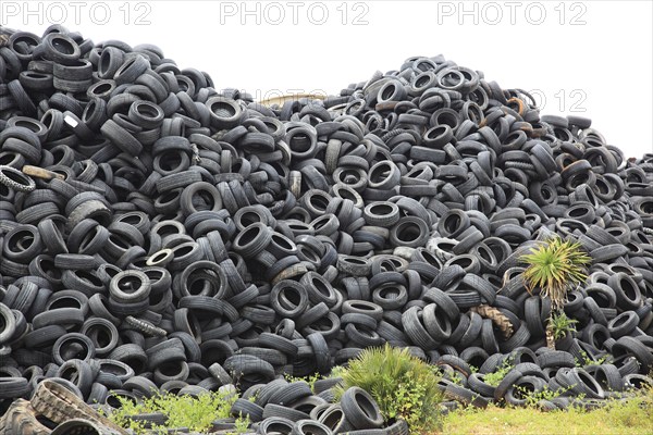 Old car tyres lie on stockpiles for recycling