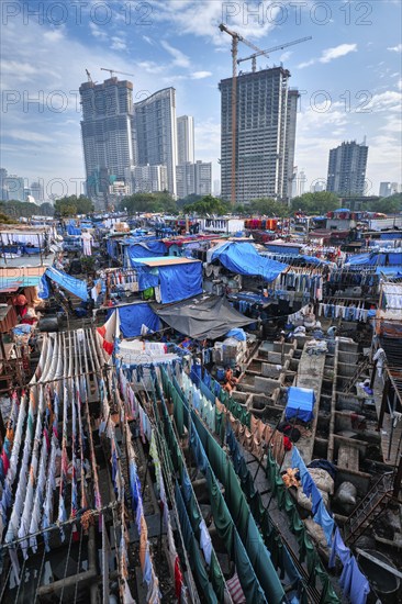 MUMBAI, INDIA, OCTOBER 31, 2019: Dhobi Ghat (Mahalaxmi Dhobi Ghat) is open air laundromat lavoir in Mumbai, India with laundry drying on ropes. Now signature landmark tourist attractions of Mumbai