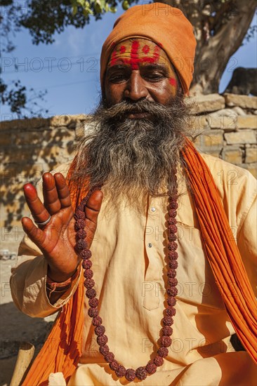 JAISALMER, INDIA, NOVEMBER 28, 2012: Indian sadhu (holy man) blessing. Sadhus are holy men who live ascetic life and focus on spiritual practice of Hinduism