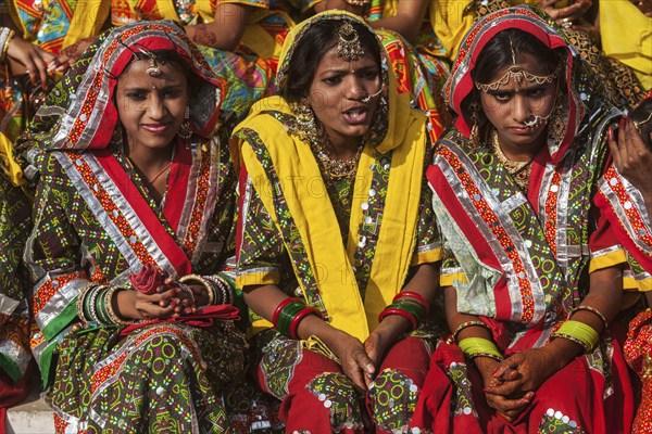 PUSHKAR, INDIA, NOVEMBER 21, 2012: Unidentified Rajasthani girls in traditional outfits prepare for dance perfomance at annual camel fair Pushkar Mela in Pushkar, Rajasthan, India, Asia