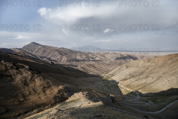 View of mountain landscape and pass road at Tyibel Pass, Song Kul Too mountain range, Naryn region, Kyrgyzstan, Asia