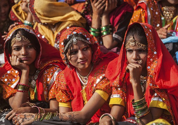 PUSHKAR, INDIA, NOVEMBER 21, 2012: Unidentified Rajasthani girls in traditional outfits prepare for dance perfomance at annual camel fair Pushkar Mela in Pushkar, Rajasthan, India, Asia