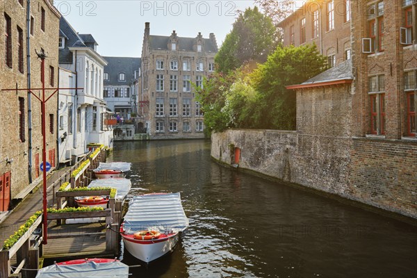 Famous place of Bruges, Rozenhoedkaai old houses along canal with tree and boats. Brugge, Belgium, Europe