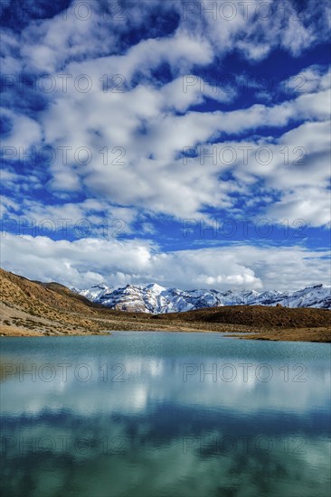 Himalayas mountains refelcting in mountain lake Dhankar Lake. Spiti Valley, Himachal Pradesh, India, Asia