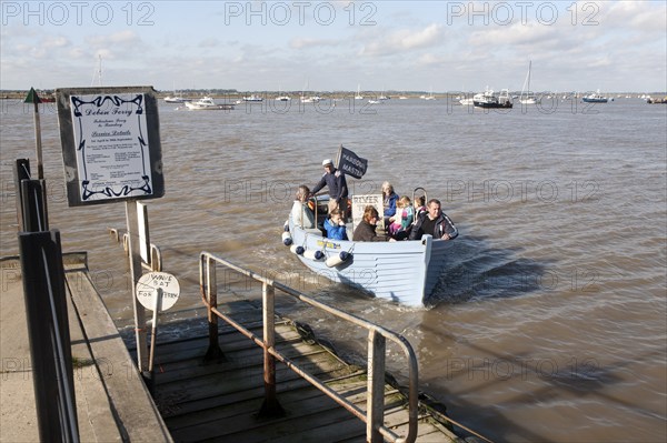 Small ferry boat crossing River Deben between Felixstowe Ferry and Bawdsey Quay, Suffolk, England, UK