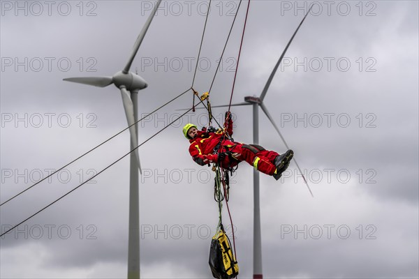 Height rescuers from the Oberhausen fire brigade practise abseiling from a wind turbine from a height of 150 metres after rescuing an accident victim from the nacelle, Issum, North Rhine-Westphalia, Germany, Europe