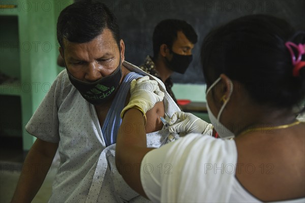 Beneficiaries receives dose of COVID-19 coronavirus vaccine in a vaccination centre at a village in Barpeta, Assam, India on 20 September 2021