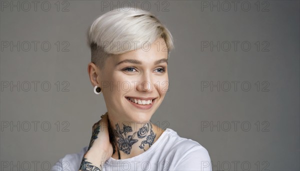 Portrait of a cheerful woman with a short haircut and visible tattoos in front of a grey background, AI generated, AI generated