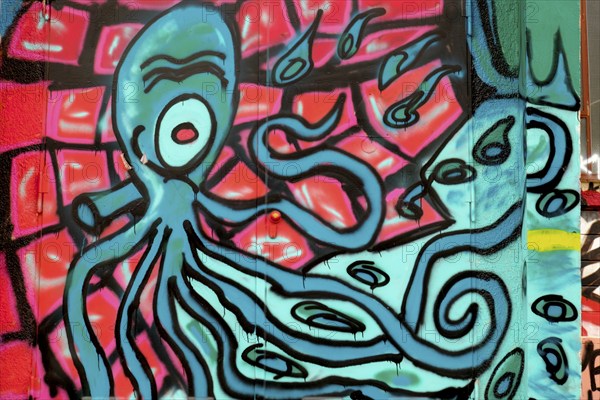 A colourful graffiti of an octopus with outstretched tentacles on an urban wall, Rhineland-Palatinate, Germany, Europe