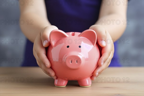 Child's hands holding pink piggy bank. KI generiert, generiert, AI generated