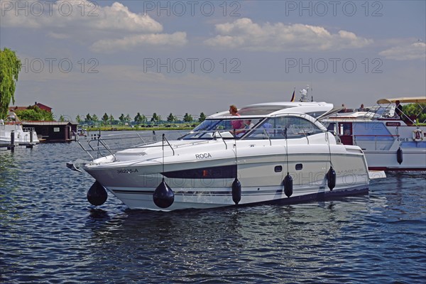 Europe, Germany, Mecklenburg-Western Pomerania, island town of Malchow, Lake Malchow, at the swing bridge, motor yacht, Malchow, Mecklenburg-Western Pomerania, Germany, Europe