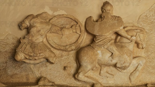 Stone relief of a horseman in battle, battle of the Greeks against the Amazons, richly detailed carving in sandstone, Archaeological Museum, Archea Korinthos, Corinth, Peloponnese, Greece, Europe