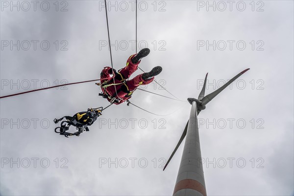 Height rescuers from the Oberhausen fire brigade practise abseiling from a wind turbine from a height of 150 metres after rescuing an accident victim from the nacelle, Issum, North Rhine-Westphalia, Germany, Europe