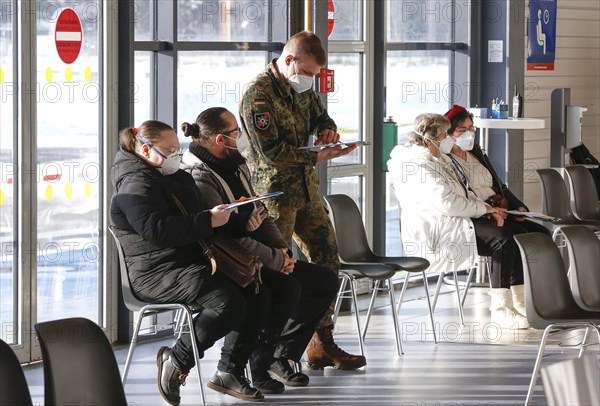 Vaccinees and a soldier of the German Armed Forces in the vaccination centre in Terminal 5 of BER Airport, Schönefeld, 15.02.2021